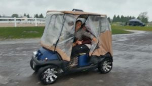 The golf cart even came prepared for the rain. Miranda Lepore and Kristin McLaren kept dry inside!