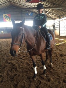 Zoe Richardson practicing riding with the Equicube in her lesson.