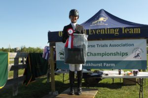 Devon Svoboda celebrating her 1st place finish in the Non-Champs Preliminary division on the podium.